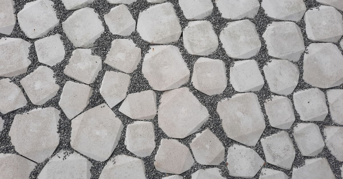 Top view of a geometric stone pathway with white rocks and gravel.