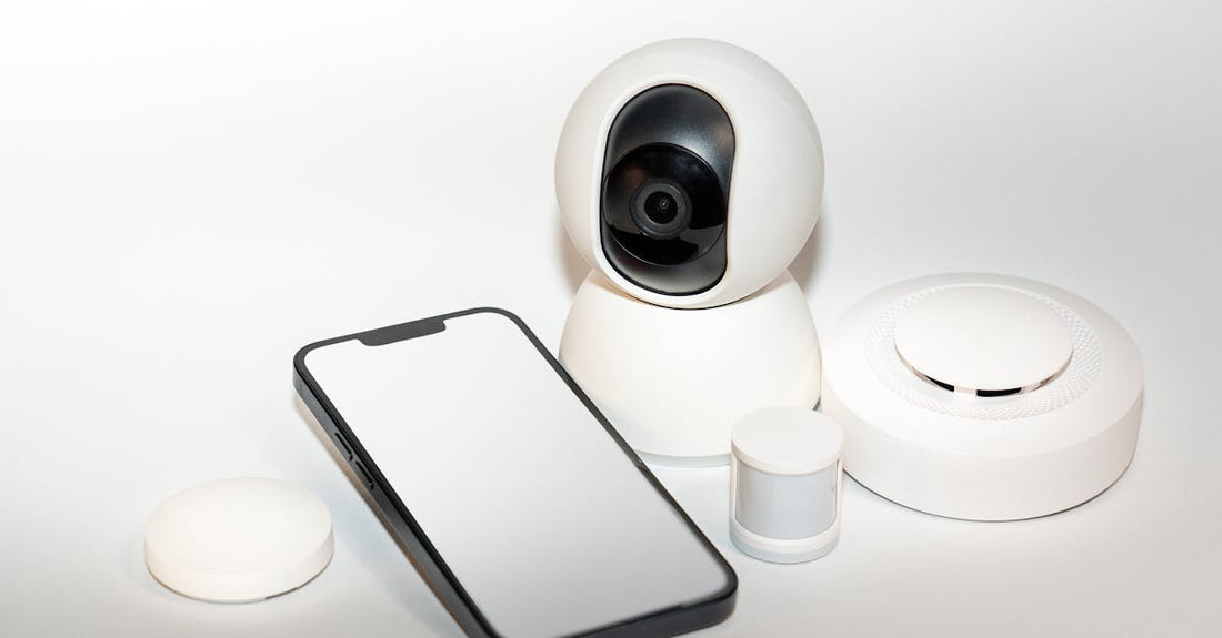 Collection of smart home security gadgets with a smartphone display.