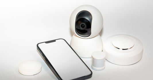 Collection of smart home security gadgets with a smartphone display.