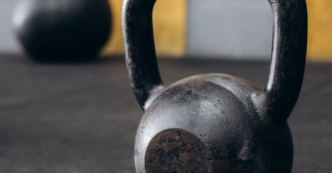 Rusty kettlebell on gym floor with blurred background. Perfect for fitness themes.