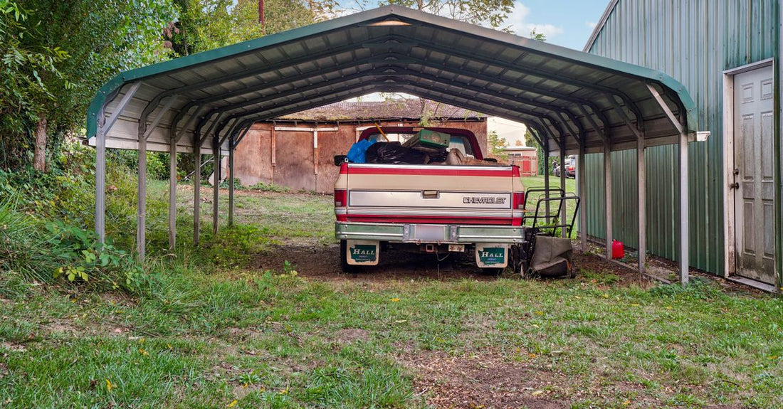 A Chevrolet truck loaded with items parked under a metal carport.