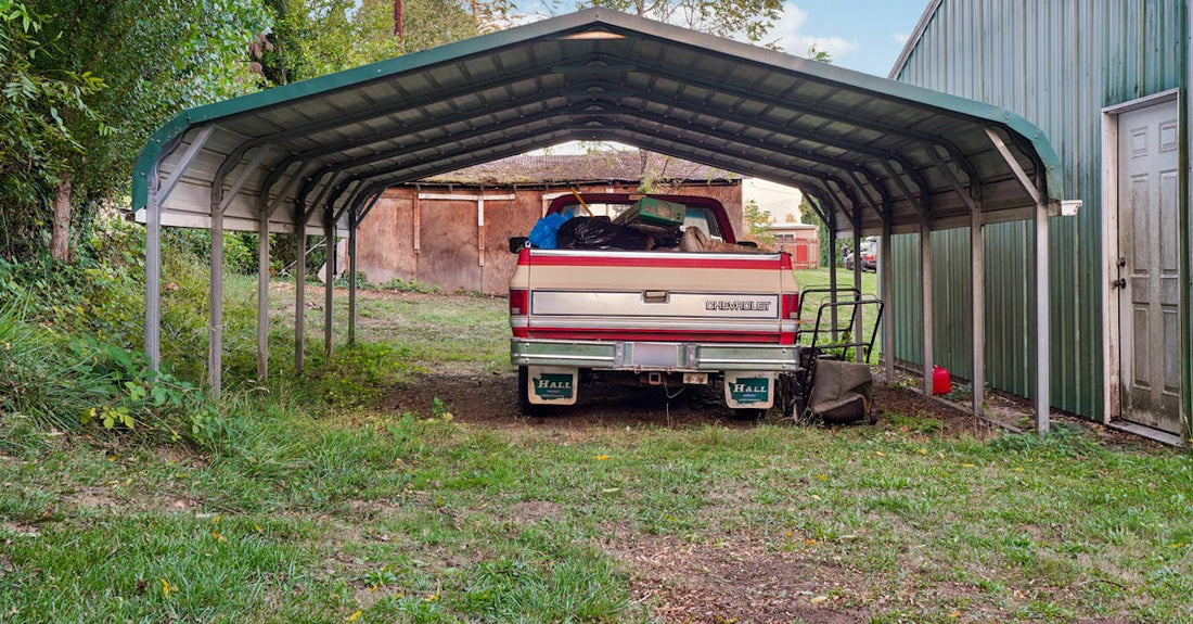 A Chevrolet truck loaded with items parked under a metal carport.