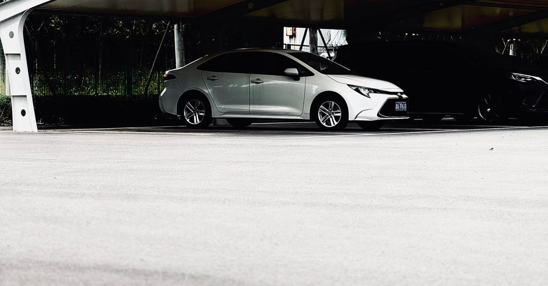 A modern car parked under a sleek canopy in an urban environment, offering ample parking space.