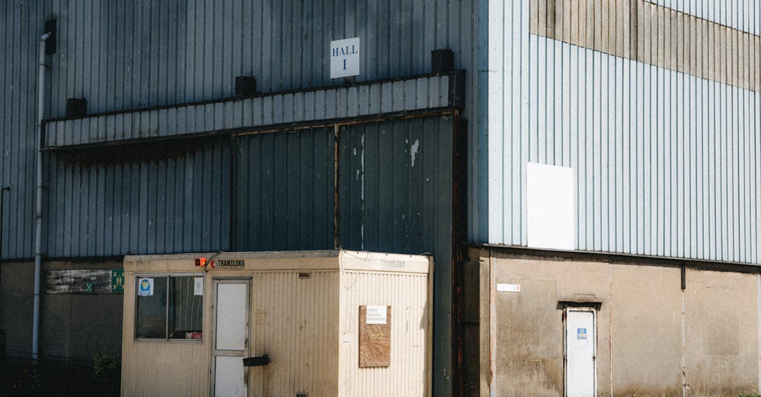 Outdoor view of a commercial warehouse with a small office in Dunkerque, France.