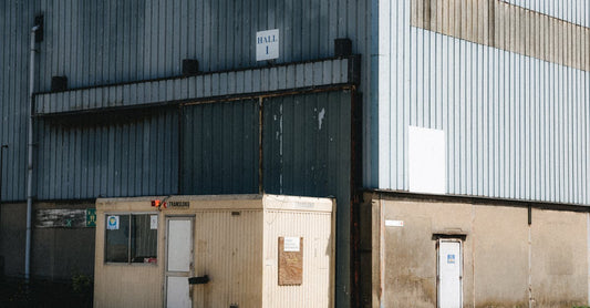 Outdoor view of a commercial warehouse with a small office in Dunkerque, France.