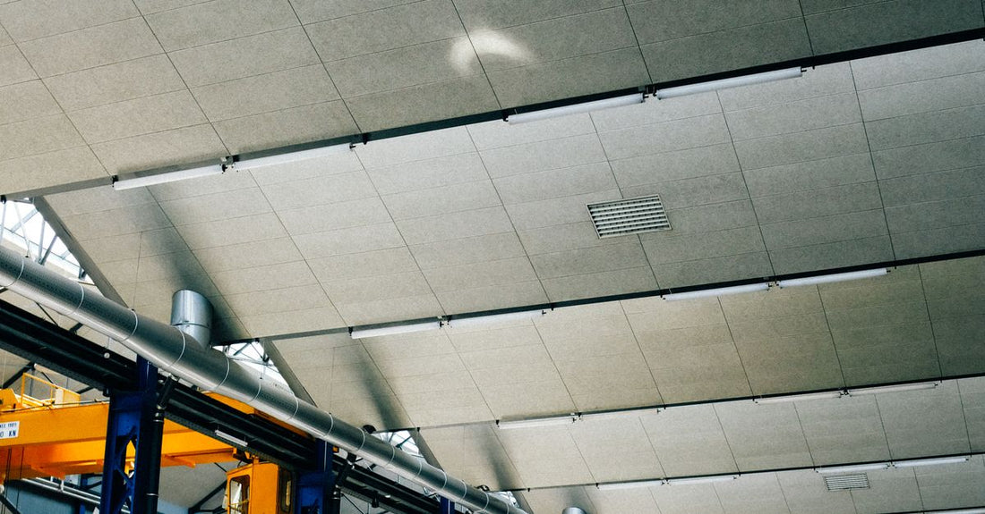 Spacious indoor warehouse with steel beams and machinery, ideal for industrial applications.