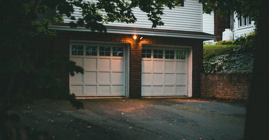 Warm evening view of a suburban garage with soft lighting creating a cozy atmosphere.